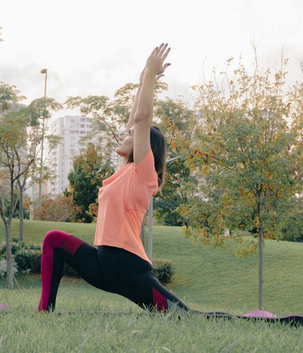 Woman in a calm yoga pose, embodying wellness and balance.